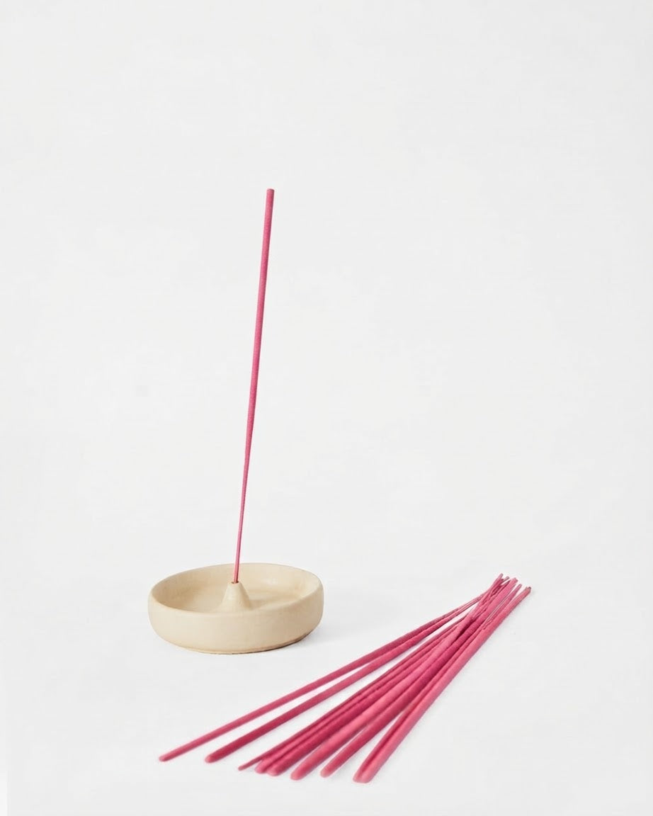 Jasmine incense stick burning in a concrete holder — Sage Botanicals Co