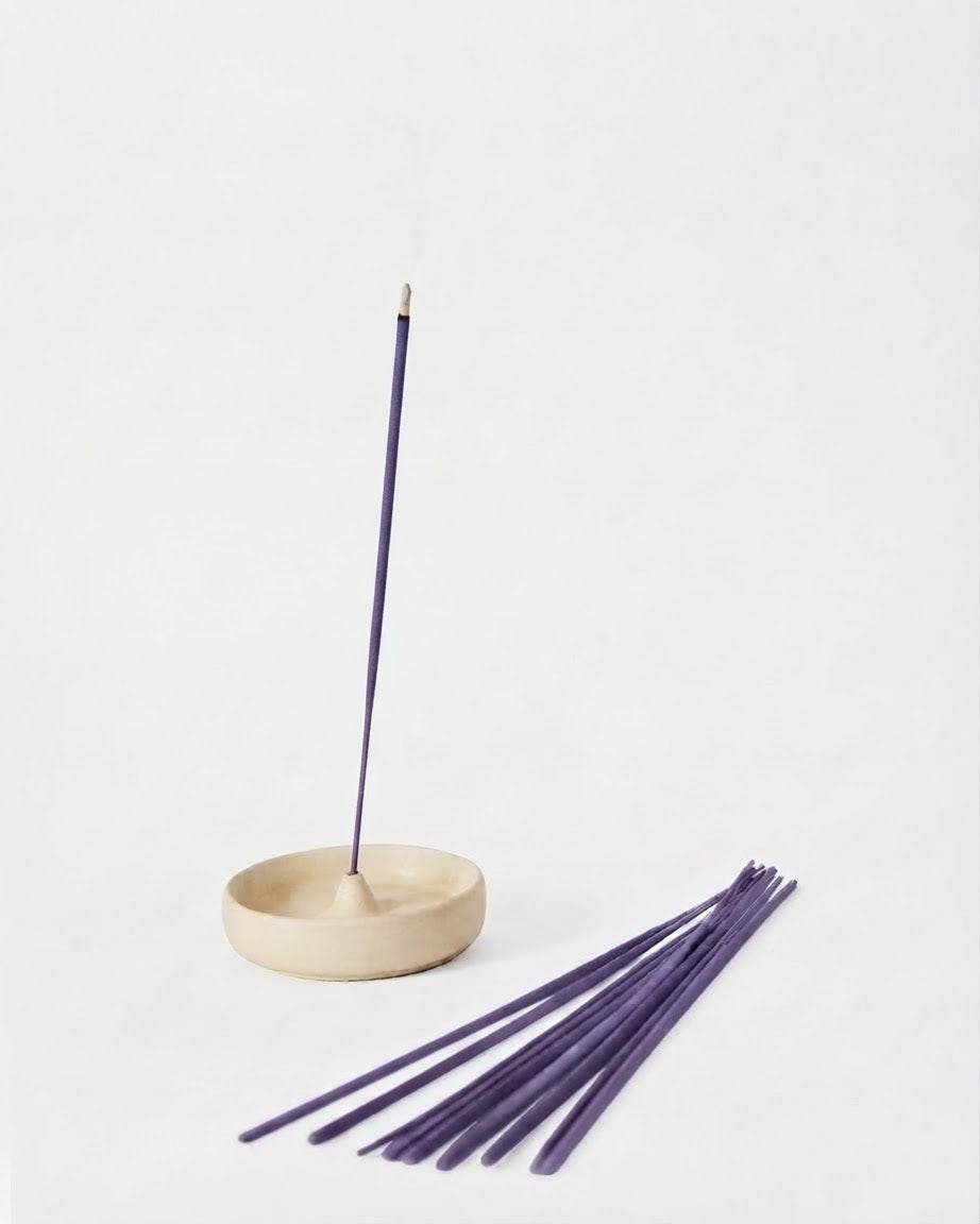 Lavender incense stick burning in a concrete holder — Sage Botanicals Co
